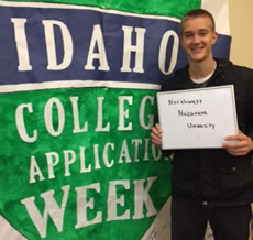 Student holding I applied sign